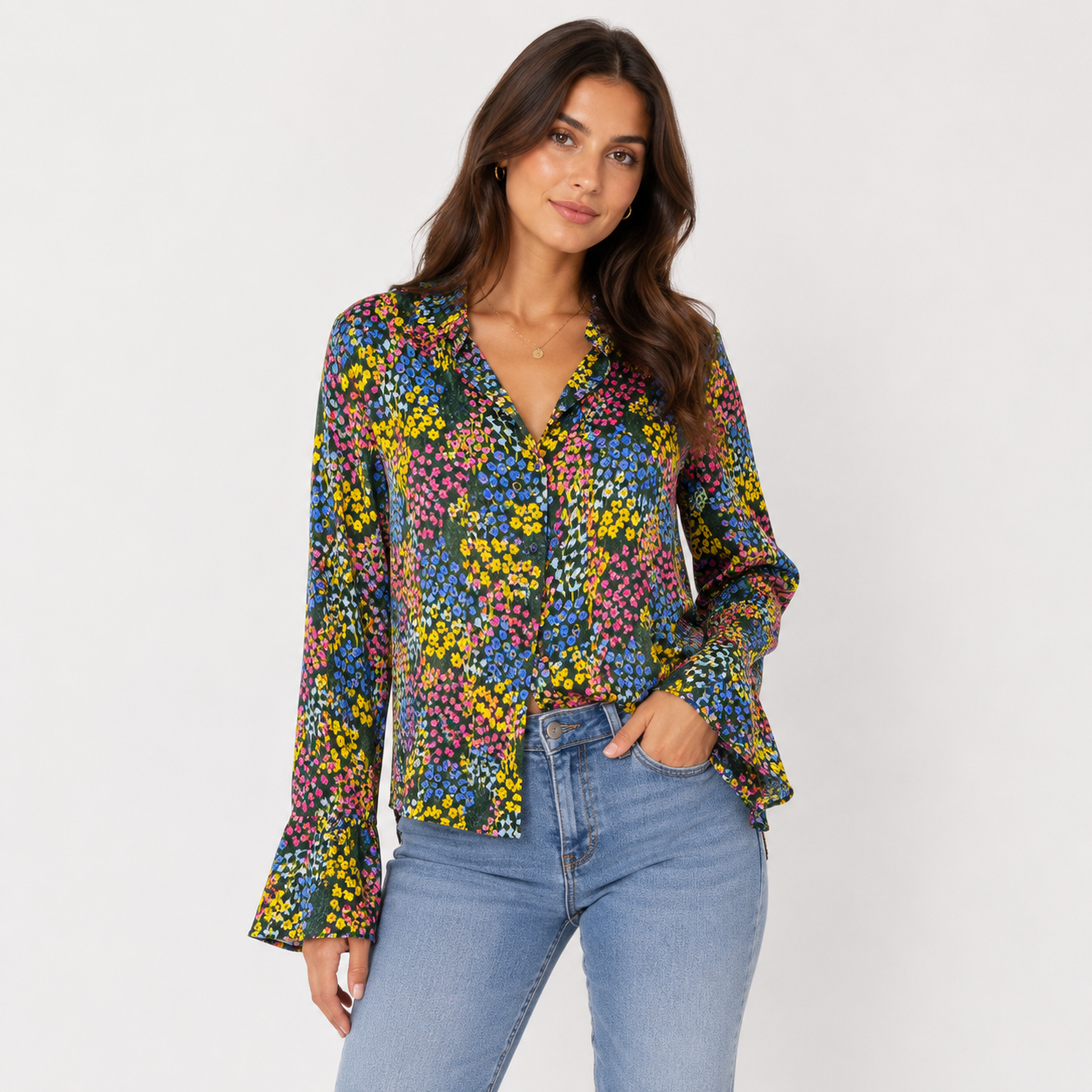 Woman wearing a colorful floral blouse and blue jeans on a white background
