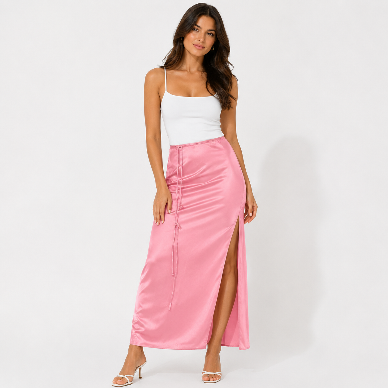 Woman wearing a white top and pink skirt on a white background