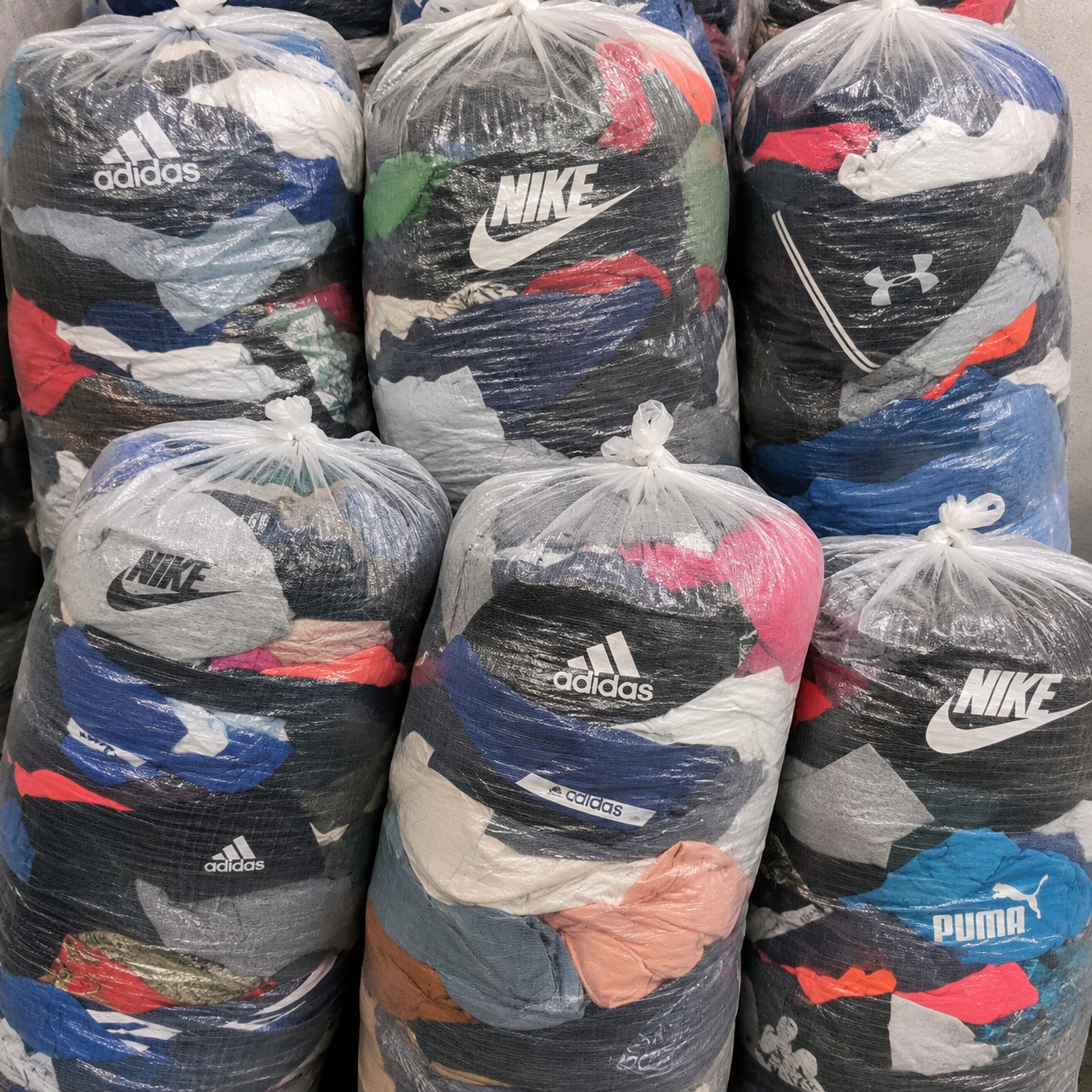 Original unsorted second hand clothing sacks with mixed branded and everyday fashion