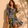 Woman wearing a floral dress against a beige wall